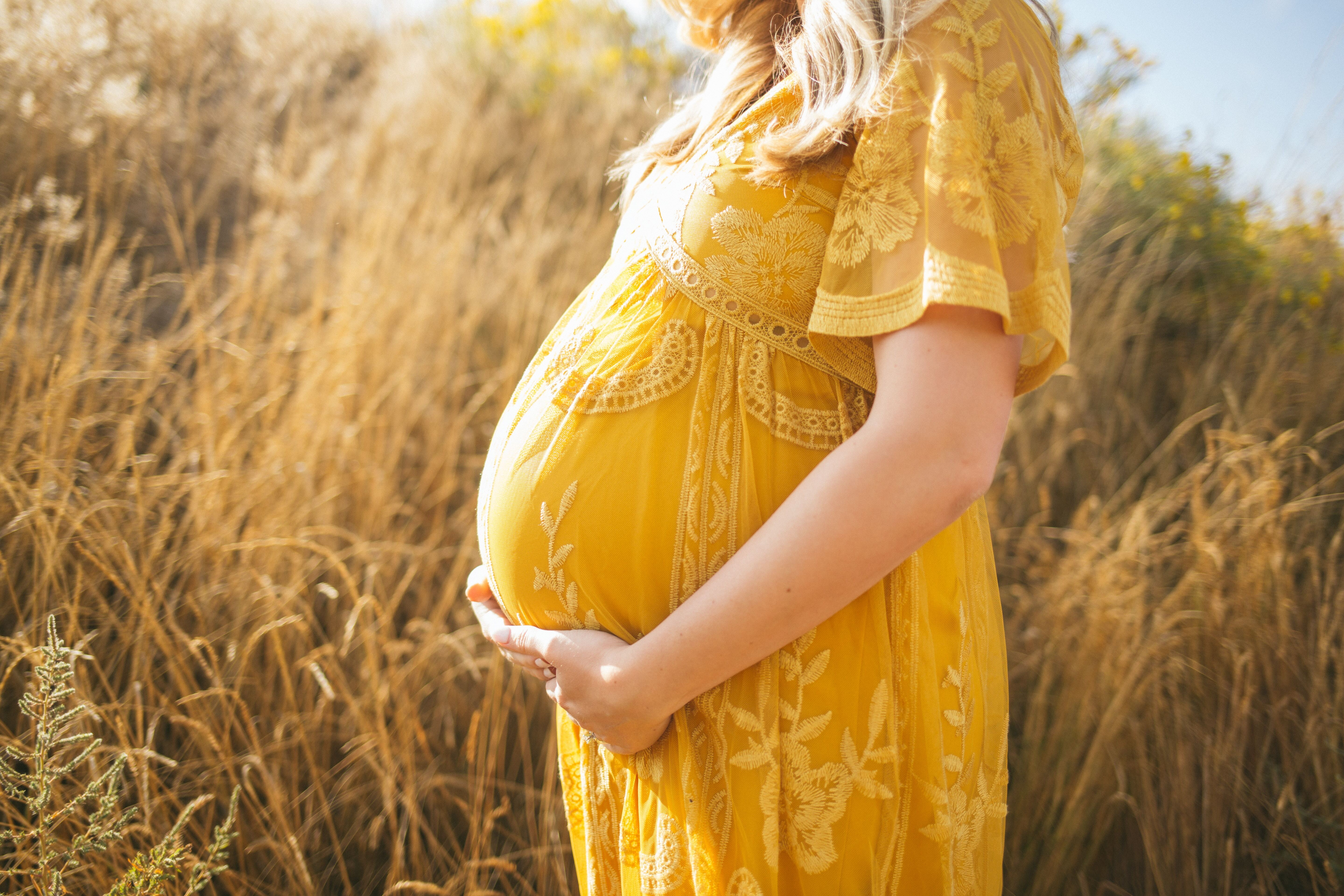 Pregnant woman holding stomach